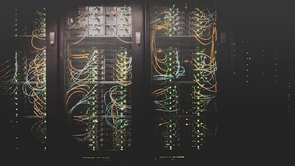 Data centre corridor where full height turnstiles control one-person-at-a-time entry